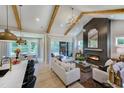 Open concept living space featuring high ceilings, fireplace, and access to outdoor patio at 3218 Bruce Garner Rd, Creedmoor, NC 27522
