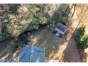 Aerial view of backyard with shed, green chairs, and surrounding trees at 40 Ringneck Ct, Lillington, NC 27546