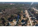 Aerial view of a neighborhood with single Gathering homes surrounded by trees at 40 Ringneck Ct, Lillington, NC 27546