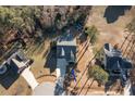 Birds eye view of a single Gathering home with a long driveway and surrounding trees at 40 Ringneck Ct, Lillington, NC 27546
