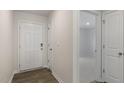 A bright entryway features wood-look flooring and a view into the adjacent carpeted room at 401 Citron St, Sanford, NC 27332