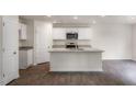 Modern kitchen featuring a central island, granite countertops, and ample cabinet space at 409 Citron St, Sanford, NC 27332