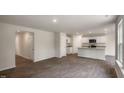 Open concept kitchen with stainless appliances, granite countertops, and a dining area at 409 Citron St, Sanford, NC 27332