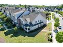 Beautiful townhome featuring a well-maintained lawn, a back porch, and charming architectural details at 4137 Strendal Dr, Cary, NC 27519