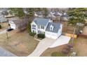 Aerial view of a two-story home with an attached garage in a residential community at 415 Moonlight Dr, Fuquay Varina, NC 27526