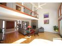 Bright living room with hardwood floors, stone fireplace, and a soaring ceiling at 4332 Blossom Hill Ct, Raleigh, NC 27613