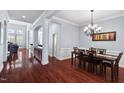 Formal dining area with dark wood floors and elegant chandelier at 4711 Marena Pl, Durham, NC 27707