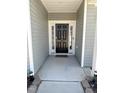 Inviting front door entrance with sidelights and decorative 'hello' decal at 5 Misty Grove Trl, Franklinton, NC 27525