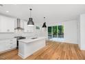 Bright kitchen featuring white cabinets, stainless steel appliances, and an island at 509 Colleton Rd, Raleigh, NC 27610