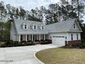 Desirable craftsman-style home with a manicured lawn, brick base, a welcoming porch, and an attached two car garage at 515 Sanctuary Trl, Cameron, NC 28326