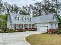 Desirable craftsman-style home with a manicured lawn, brick base, a welcoming porch, and an attached two car garage at 515 Sanctuary Trl, Cameron, NC 28326