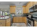 Cozy kitchen featuring stainless steel appliances, wooden cabinets, and lots of counter space at 6306 Winding Arch Dr, Durham, NC 27713