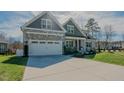Inviting home with a well-manicured lawn and a spacious driveway for parking at 65 Walking Trl, Youngsville, NC 27596