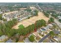 Wide aerial view of a residential neighborhood near golf course with a tree-lined street at 7 Windsor Glen Dr, Durham, NC 27703