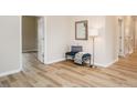 Bright hallway featuring wood-look flooring, neutral walls, and a stylish blue bench with decorative pillows at 738 Everett St, Burlington, NC 27215
