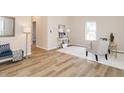 Spacious living room with wood-look flooring, two chairs, a white geometric rug, and a decorative bench at 738 Everett St, Burlington, NC 27215