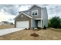 Charming two-story home with neutral-colored siding and a front-entry garage at 801 Berkeley Glen Rd, Zebulon, NC 27597