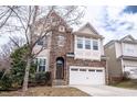Attractive two-story home featuring a stone facade and an integrated two-car garage at 804 Long Meadows Rd, Chapel Hill, NC 27516