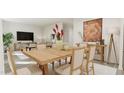 Open-concept dining area featuring a light wood table set with seating for six and living space at 81 St Andrews Dr, Zebulon, NC 27597