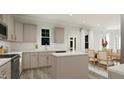 Spacious kitchen featuring stainless steel appliances, an island, and light-colored cabinets at 81 St Andrews Dr, Zebulon, NC 27597