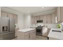 Beautiful kitchen featuring stainless steel appliances, a large island, and light-colored cabinets at 81 St Andrews Dr, Zebulon, NC 27597