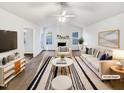 Bright living room featuring a vaulted ceiling, fireplace, and stylish decor at 8425 Fawncrest Dr, Raleigh, NC 27603