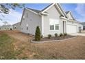 Charming gray home with a well-manicured lawn and attached garage, ideal for modern living at 88 Molly Mac Ln, Angier, NC 27501