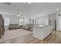 Inviting open-concept living area featuring neutral colors, plush seating, and wood-style flooring at 88 Molly Mac Ln, Angier, NC 27501