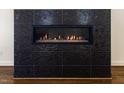 Close up of the fireplace with modern tile and gas insert at 9413 Lake Villa Way, Raleigh, NC 27614