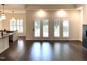 Bright, open living room with hardwood floors and large windows overlooking the backyard at 9413 Lake Villa Way, Raleigh, NC 27614