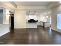 Bright, open living room with hardwood floors and access to the modern kitchen at 9413 Lake Villa Way, Raleigh, NC 27614