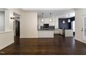 Open-concept living room that flows into kitchen, boasting hardwood floors and plenty of natural light at 9413 Lake Villa Way, Raleigh, NC 27614