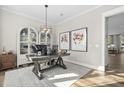 Stylish home office featuring a modern desk, elegant decor, and hardwood floors at 104 Sage Oak Ln, Holly Springs, NC 27540