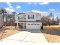 Inviting two-story home with a two-car garage and a well-manicured front lawn at 106 Capanne Ct, Clayton, NC 27527