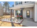 Cozy front porch with seating area and stylish landscaping at 106 Capanne Ct, Clayton, NC 27527