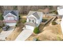 Aerial view of a charming home with a two-car garage and driveway at 108 Wagon Tie Ln, Garner, NC 27529