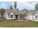 Charming one-story home featuring a well-maintained front yard and a convenient attached garage at 11228 N Radner Way, Raleigh, NC 27613