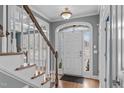 Inviting foyer with hardwood floors, staircase and traditional trim details, showcasing a bright and welcoming entryway at 1233 Dunn Creek Xing, Wake Forest, NC 27587