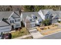 An elevated view showing a home in a residential neighborhood, with a lawn and mature trees at 153 Sharp Top Trl, Apex, NC 27502