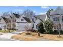 Traditional home featuring an attached garage, well-kept lawn and established greenery at 153 Sharp Top Trl, Apex, NC 27502