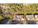 Aerial view of home showcasing mature trees, well-maintained landscaping, and neighborhood at 209 Intern Way, Durham, NC 27713