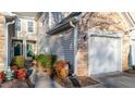 Home exterior with stone accents, siding, two car garage, and landscaped yard at 209 Intern Way, Durham, NC 27713