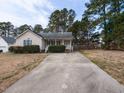 Inviting single-story home featuring a long driveway and well-maintained lawn at 212 Walnut Creek Dr, Clayton, NC 27520