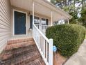 Close up of home entrance featuring brick steps and an ADT security sign at 212 Walnut Creek Dr, Clayton, NC 27520