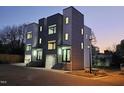 Contemporary townhome with clean lines, modern siding, well-lit entryways, and professional landscaping at 226 Woodsborough Pl, Raleigh, NC 27601