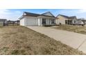A single-story home with a white exterior, attached garage, and a long driveway at 2425 Shreve Rd, Rocky Mount, NC 27801