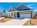 Beautiful home featuring blue siding, a well-maintained lawn, and a two-car garage at 276 Bevis Marks Dr, Fuquay Varina, NC 27526