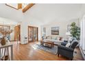 Bright living room with hardwood floors, a comfortable sofa, and natural light from large windows at 279 Box Turtle Trl, Chapel Hill, NC 27516