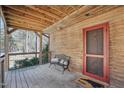 Relaxing porch area with wood walls, a comfortable bench, and a rustic wooden ceiling at 279 Box Turtle Trl, Chapel Hill, NC 27516