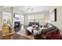 Cozy living room with a fireplace, hardwood floors, and comfortable seating arrangements at 2851 Wilkes Lake Dr, Fuquay Varina, NC 27526